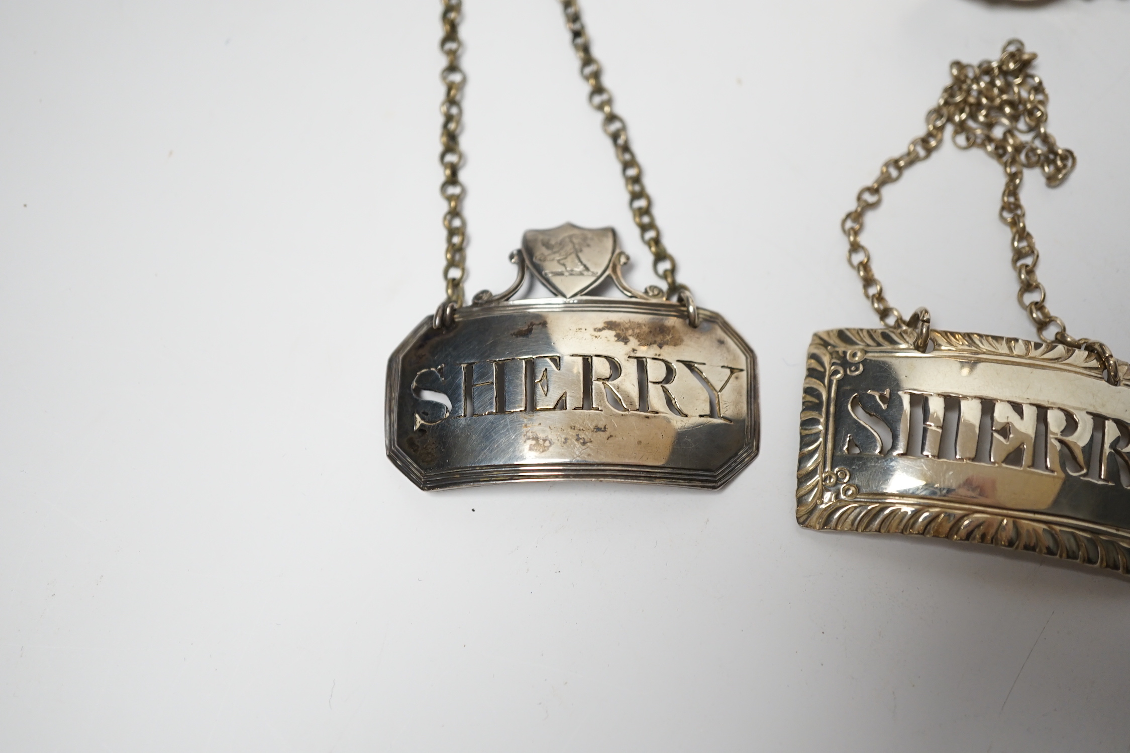 A George IV silver wine funnel, London, 1825, 12.9cm and four George III silver wine labels including pair by Phipps & Robinson, London, 1808/9.